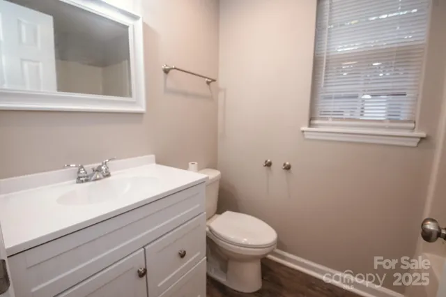 a bathroom with a sink a toilet and a window