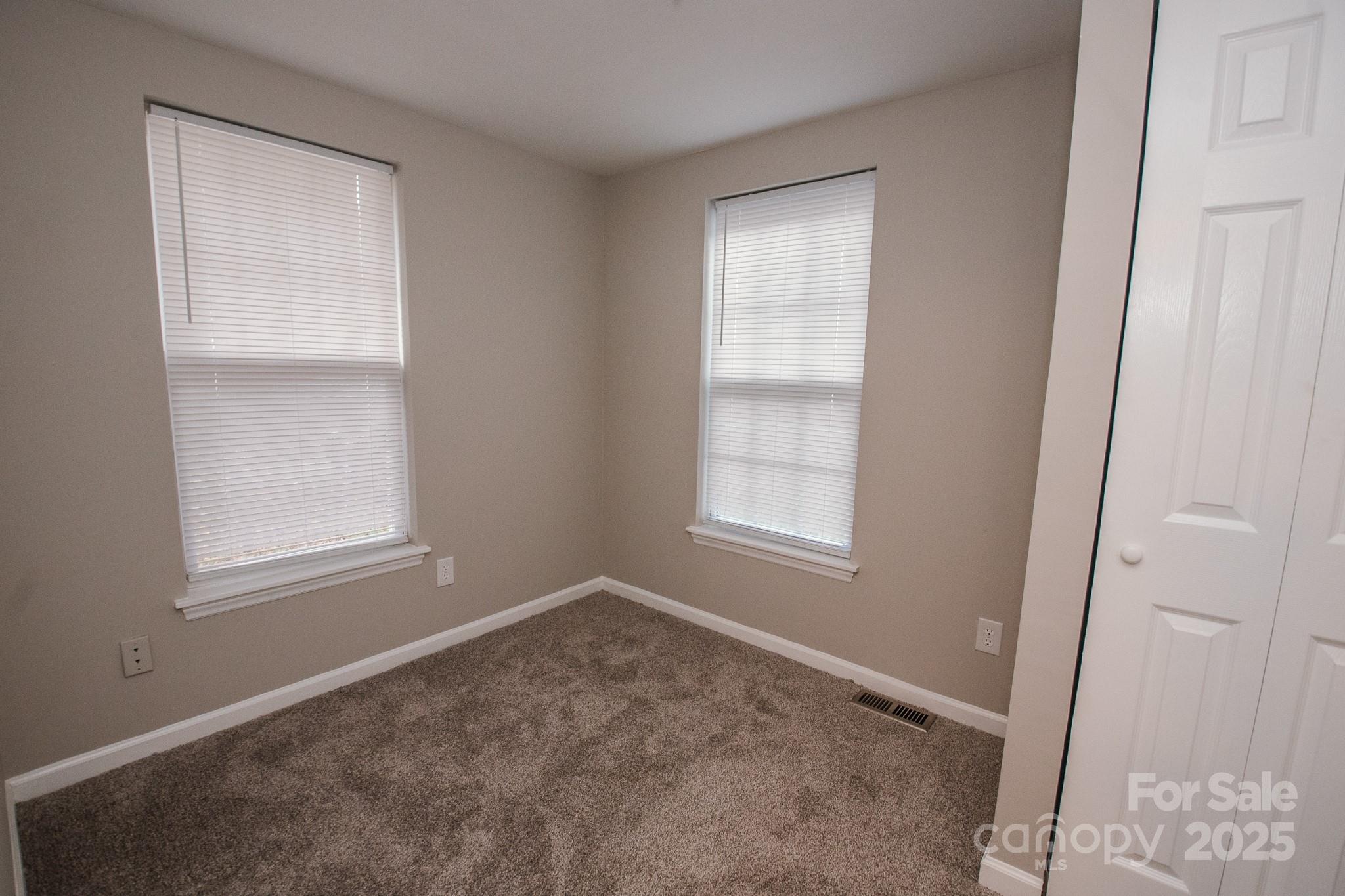 707 Summit Street Monroe, NC 28112 - Photo 19 of 23 an empty room with windows