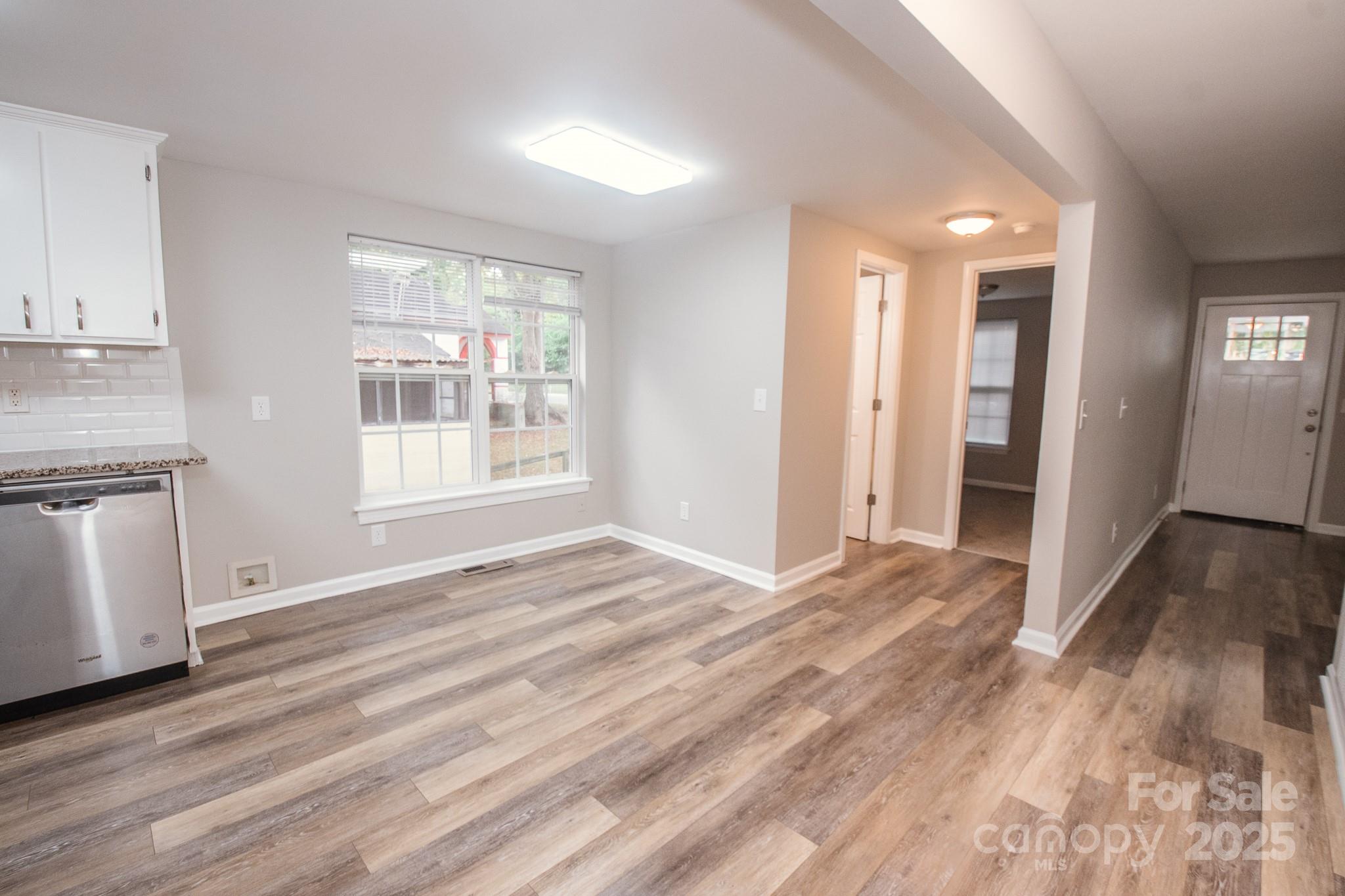 707 Summit Street Monroe, NC 28112 - Photo 21 of 23 a view of an empty room with window and wooden floor
