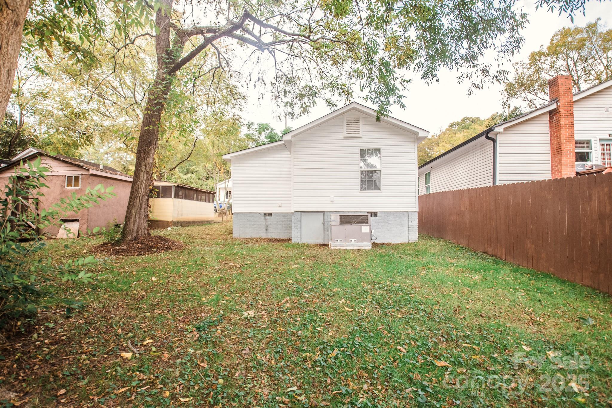707 Summit Street Monroe, NC 28112 - Photo 4 of 23 a house with green field in front of it