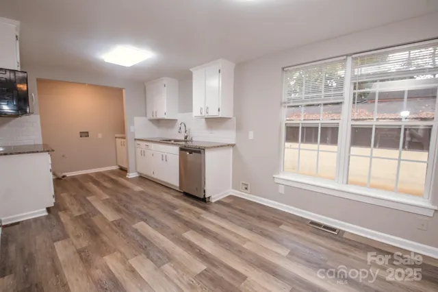 a kitchen with a stove a sink and a refrigerator