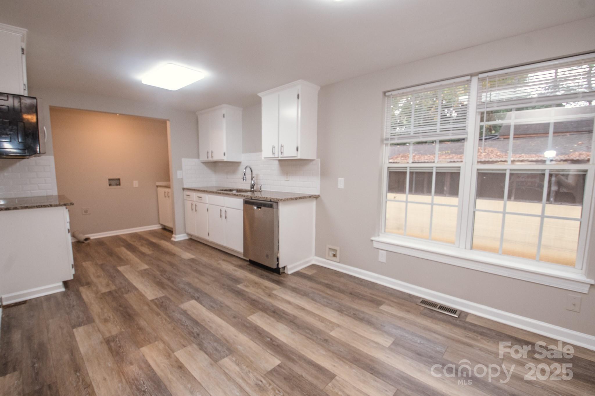 707 Summit Street Monroe, NC 28112 - Photo 8 of 23 a kitchen with a stove a sink and a refrigerator