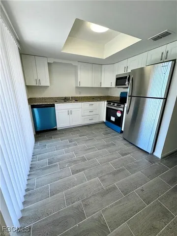 a kitchen with stainless steel appliances a refrigerator and a sink