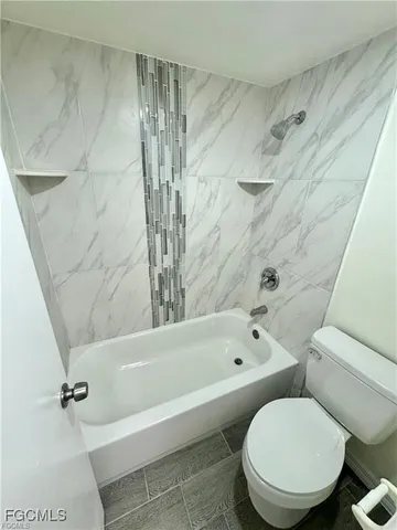 a bathroom with a toilet and a bathtub