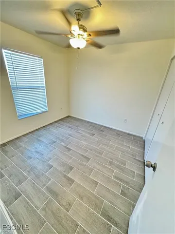 a view of an empty room with a window