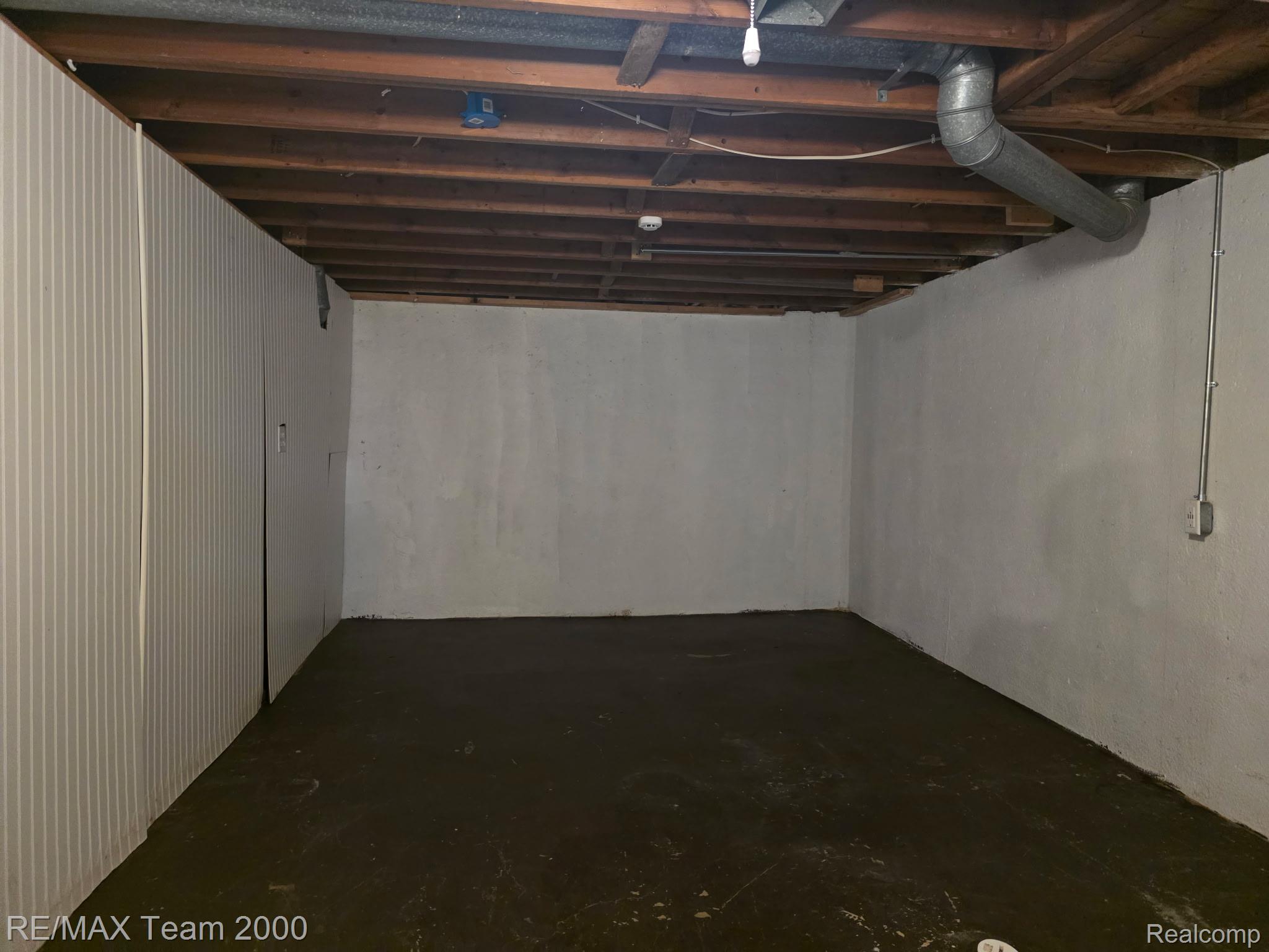 38114 Walnut Street Romulus, MI 48174 - Photo 12 of 18 Unfinished basement featuring exposed wood joists and concrete flooring
