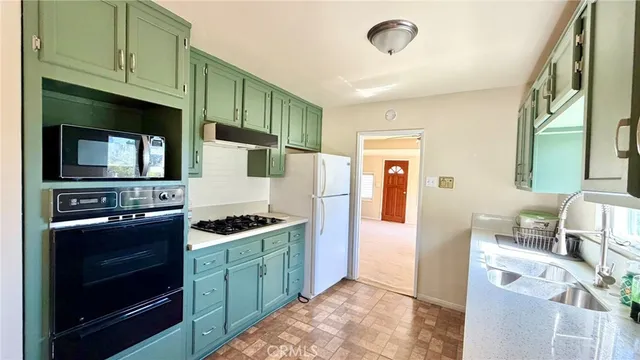 a kitchen with stainless steel appliances granite countertop a stove and a microwave