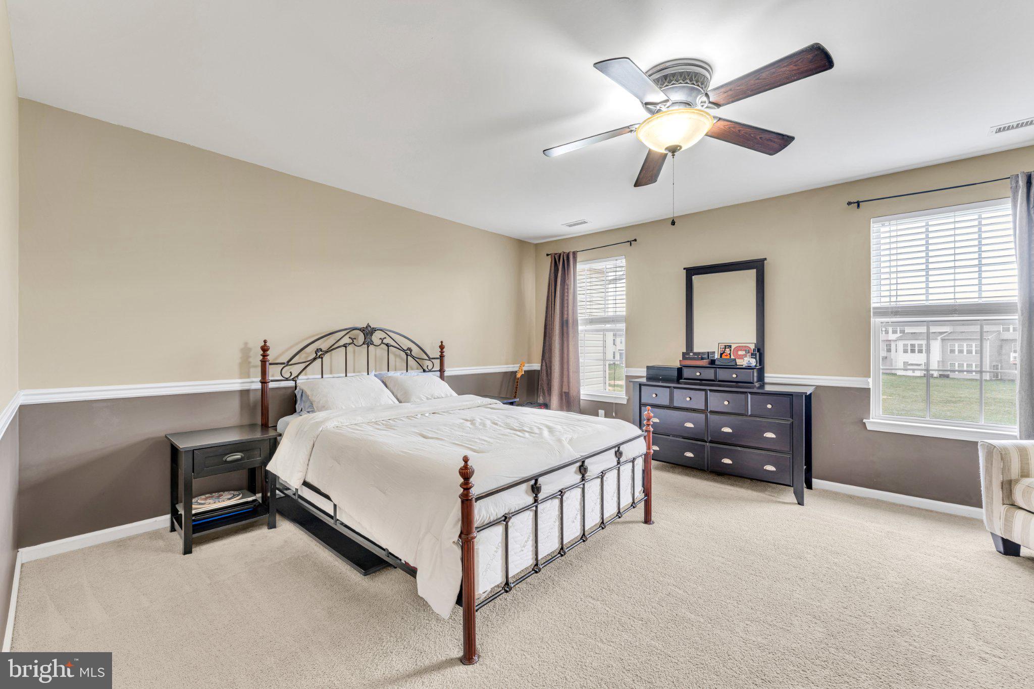1702 Exposition Drive Williamstown, NJ 08094 - Photo 11 of 34 a spacious bedroom with a bed a chandelier and windows