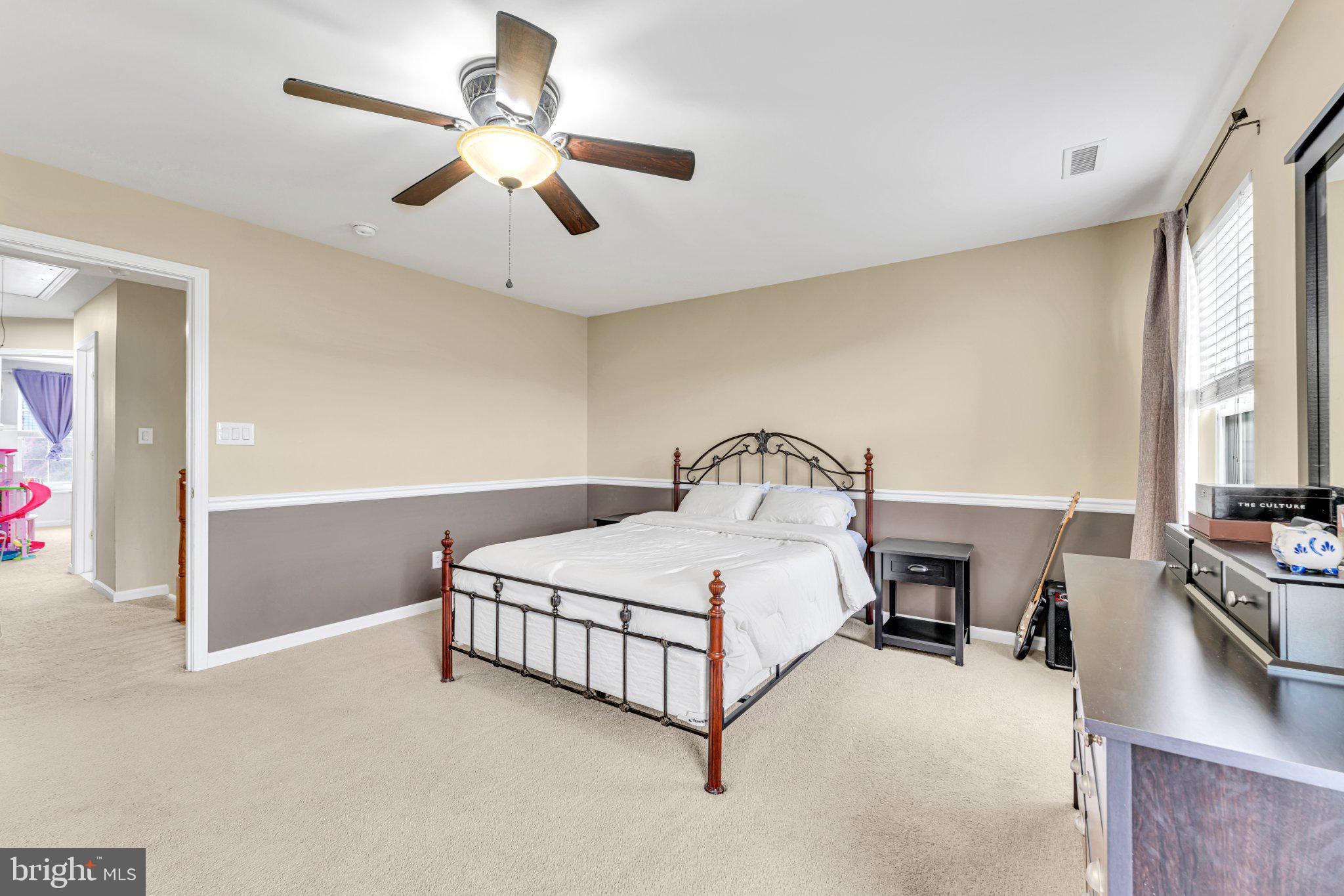 1702 Exposition Drive Williamstown, NJ 08094 - Photo 13 of 34 a spacious bedroom with a bed and a chandelier