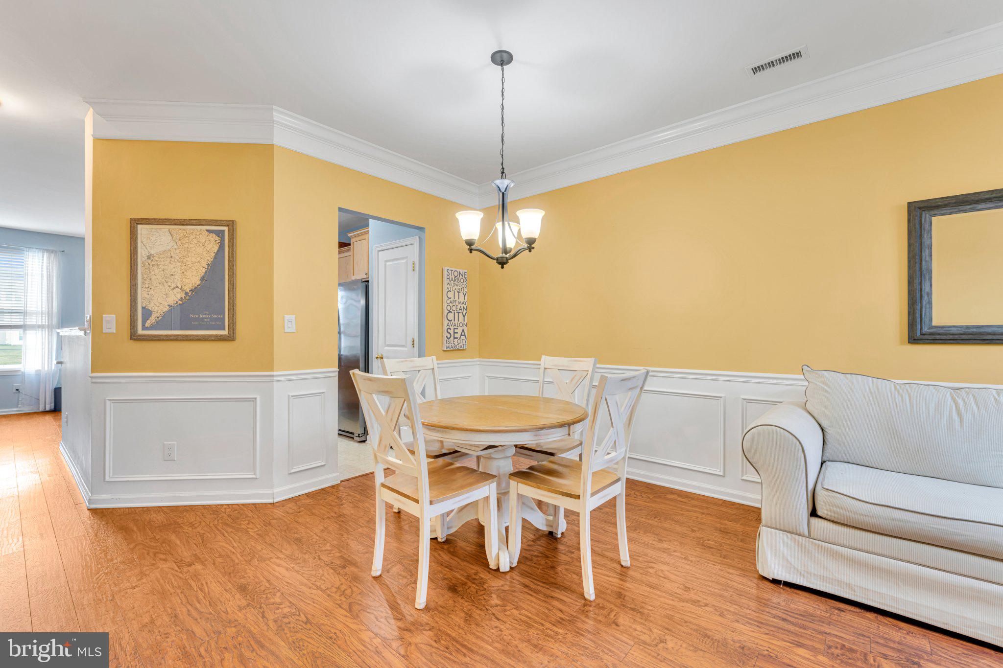 1702 Exposition Drive Williamstown, NJ 08094 - Photo 32 of 34 a view of a dining room with furniture and wooden floor
