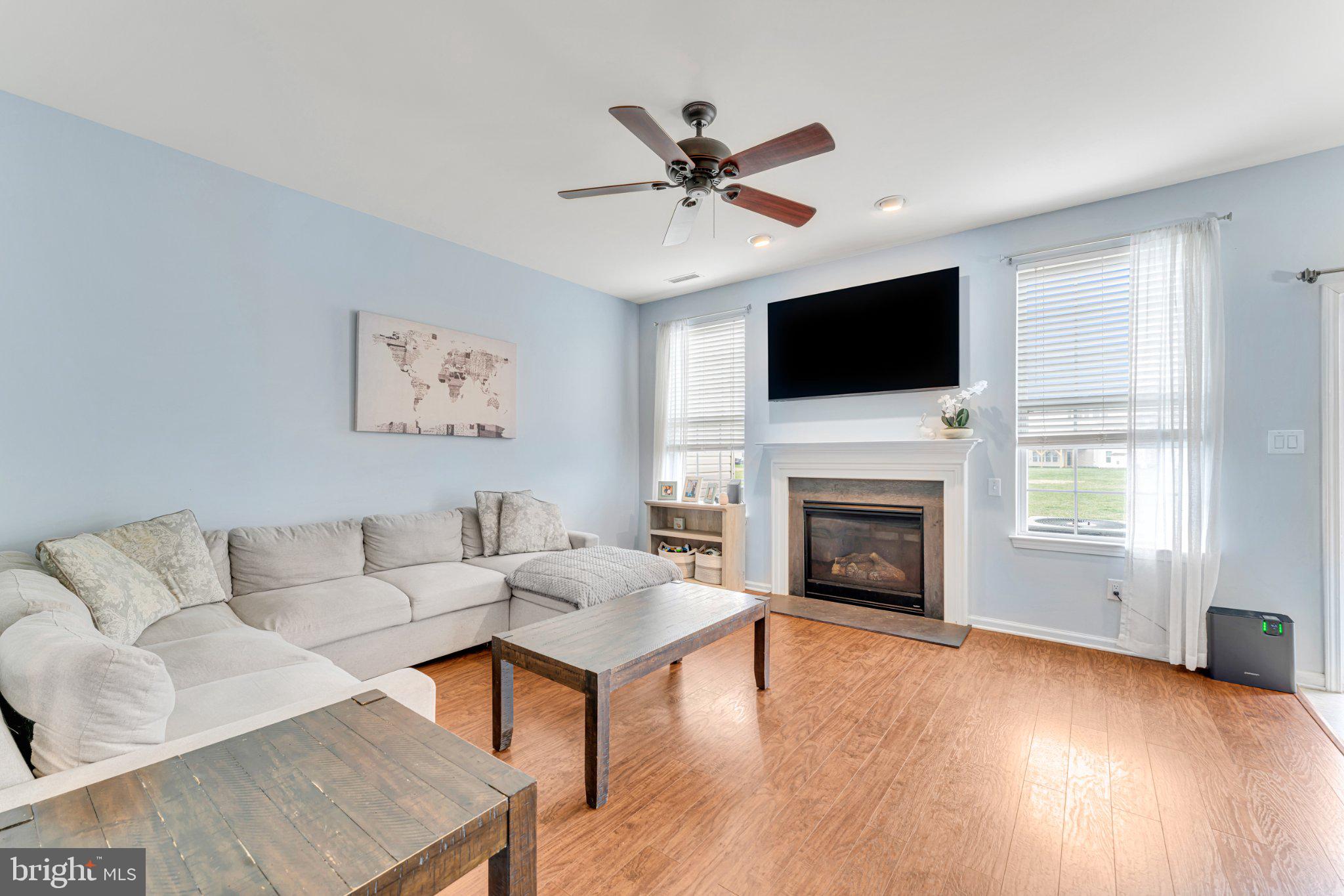 1702 Exposition Drive Williamstown, NJ 08094 - Photo 33 of 34 a living room with furniture a fireplace and a flat screen tv