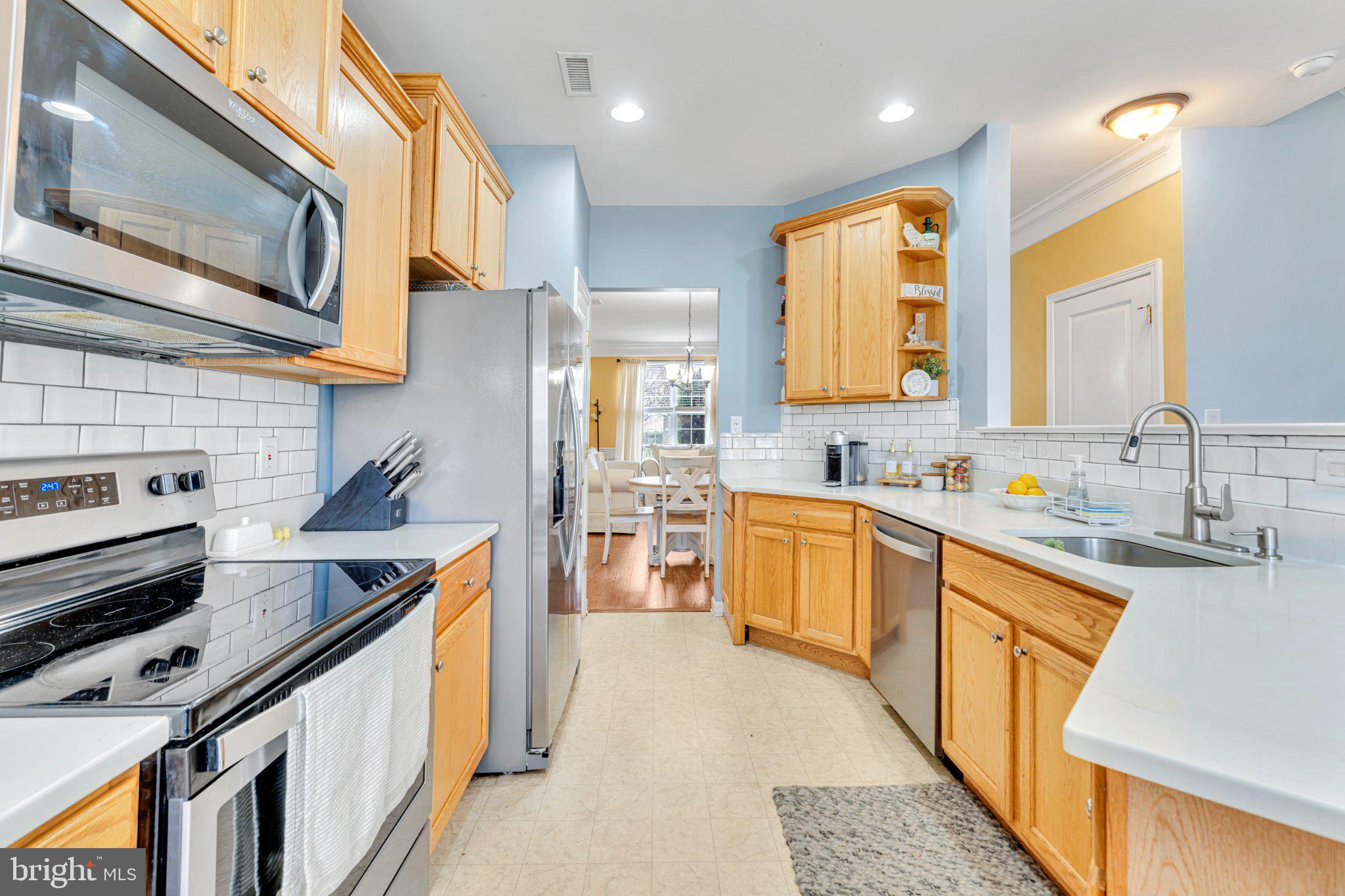 1702 Exposition Drive Williamstown, NJ 08094 - Photo 5 of 34 a kitchen with stainless steel appliances granite countertop a sink a stove and a microwave