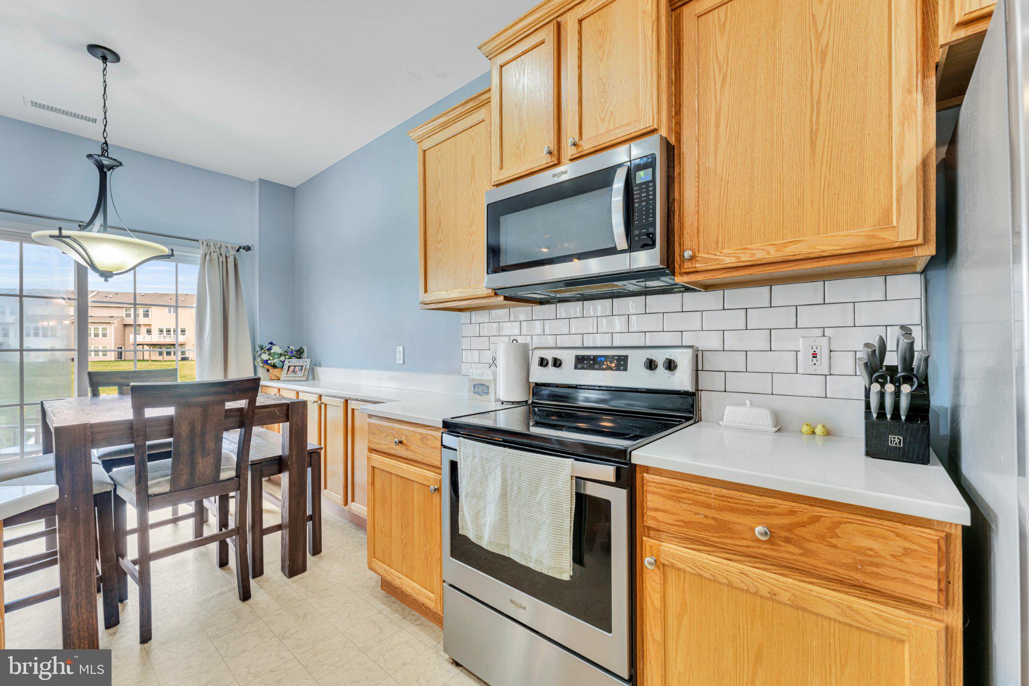 1702 Exposition Drive Williamstown, NJ 08094 - Photo 7 of 34 a kitchen with stainless steel appliances granite countertop a stove a sink and a microwave