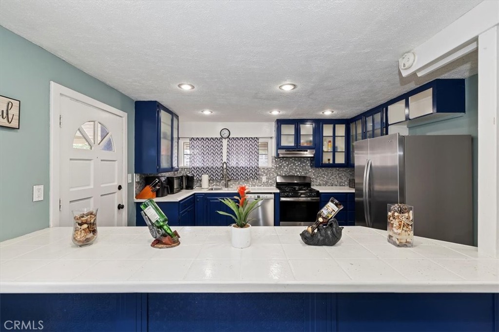 737 Edgar Avenue Beaumont, CA 92223 - Photo 13 of 43 a kitchen with a sink stainless steel appliances and cabinets