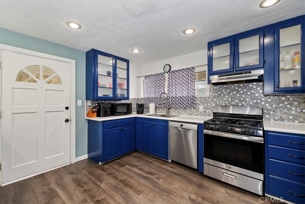 737 Edgar Avenue Beaumont, CA 92223 - Photo 14 of 43 a kitchen with stainless steel appliances granite countertop a stove and a sink