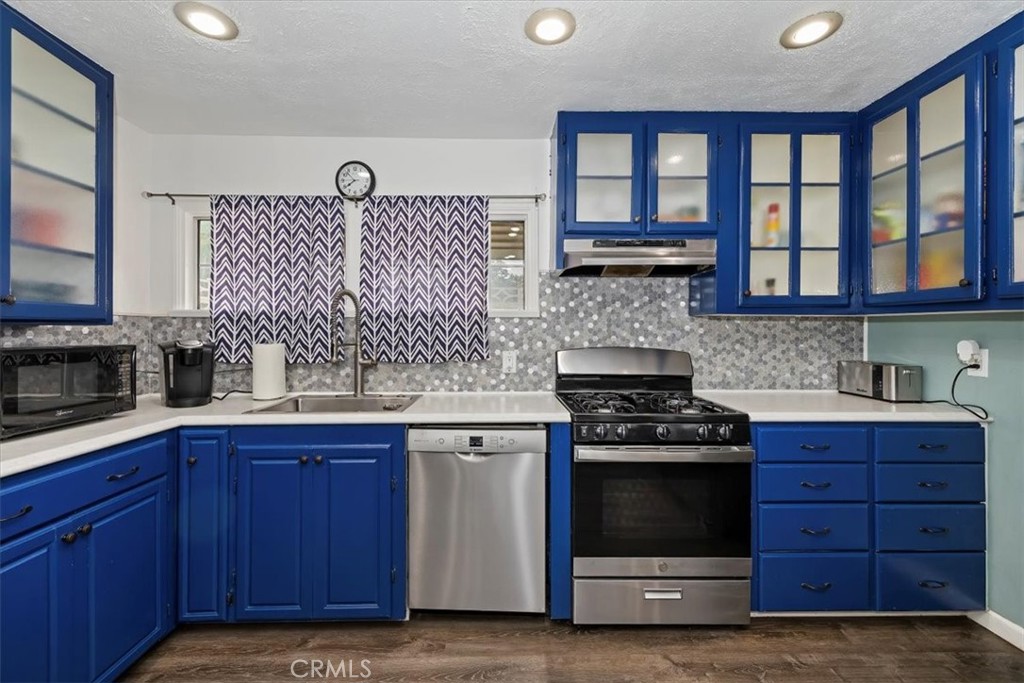 737 Edgar Avenue Beaumont, CA 92223 - Photo 17 of 43 a kitchen with granite countertop a stove and a sink