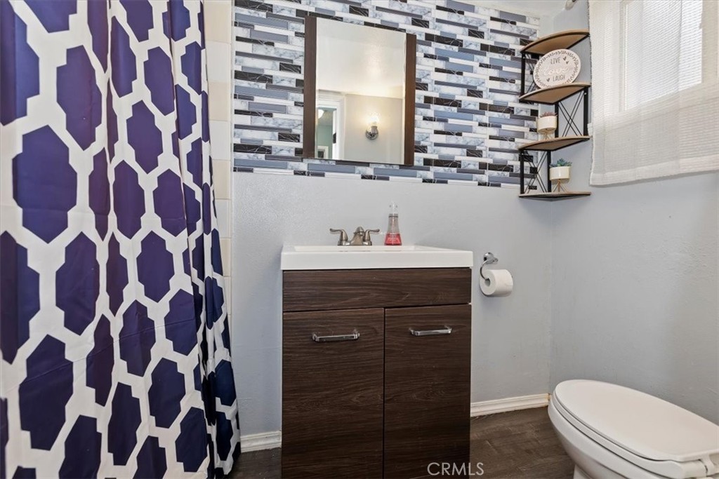 737 Edgar Avenue Beaumont, CA 92223 - Photo 21 of 43 a bathroom with a sink a toilet and a mirror