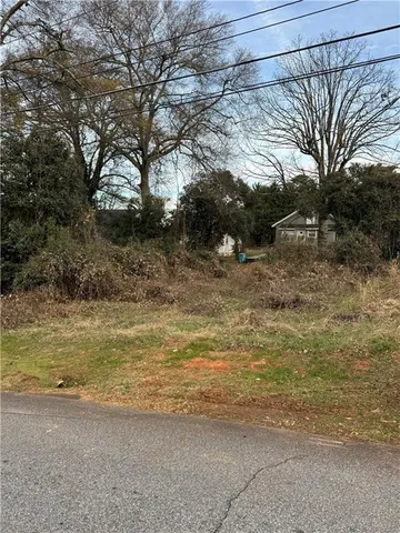 a view of a yard with a tree