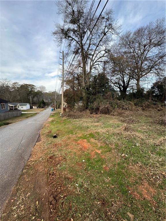 44 Troy Street Commerce, GA 30529 - Photo 3 of 7 a view of dirt yard with a large tree