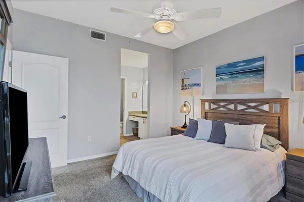 a bedroom with a bed and a flat screen tv