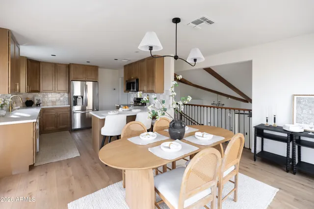 a view of a big room with wooden floor and a ceiling fan