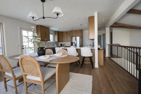 a view of a livingroom with a ceiling fan and wooden floor