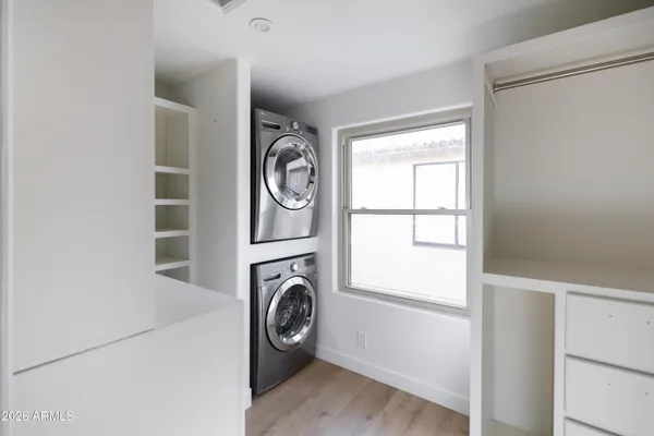 a bathroom with a granite countertop sink a toilet and a mirror