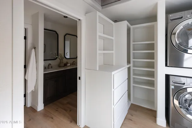 a close view of a sink a mirror and potted plants on a wall
