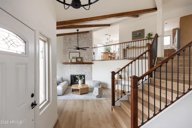 a view of entryway and hall with wooden floor