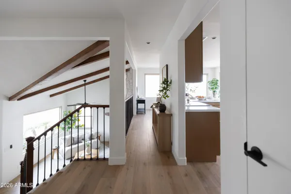 a view of entryway and hall with wooden floor
