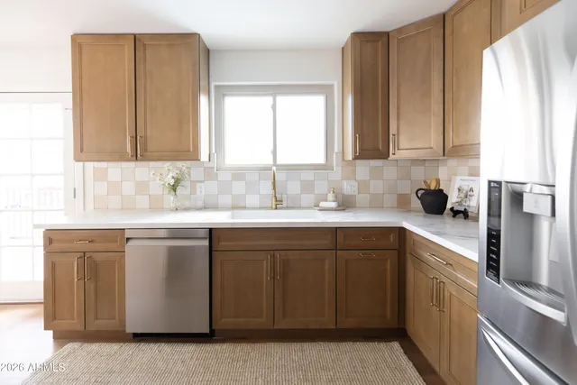 a kitchen with stainless steel appliances granite countertop a sink and a cabinets