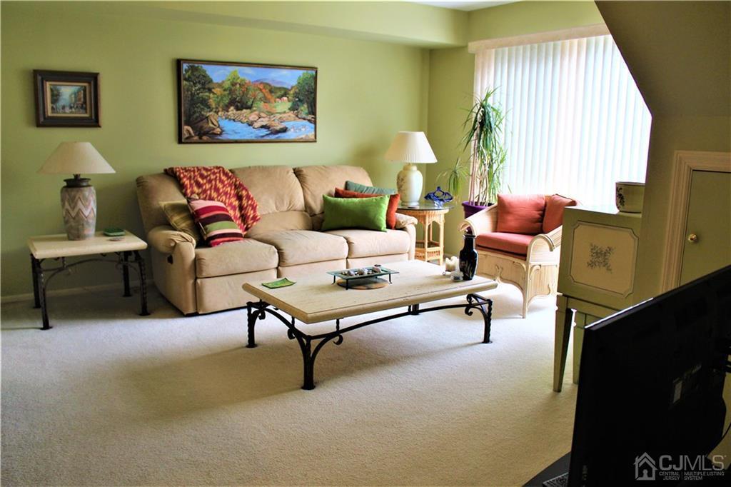 5103 Stonehedge Road, Unit 5103 Edison, NJ 08820 - Photo 16 of 25 a living room with furniture and a window