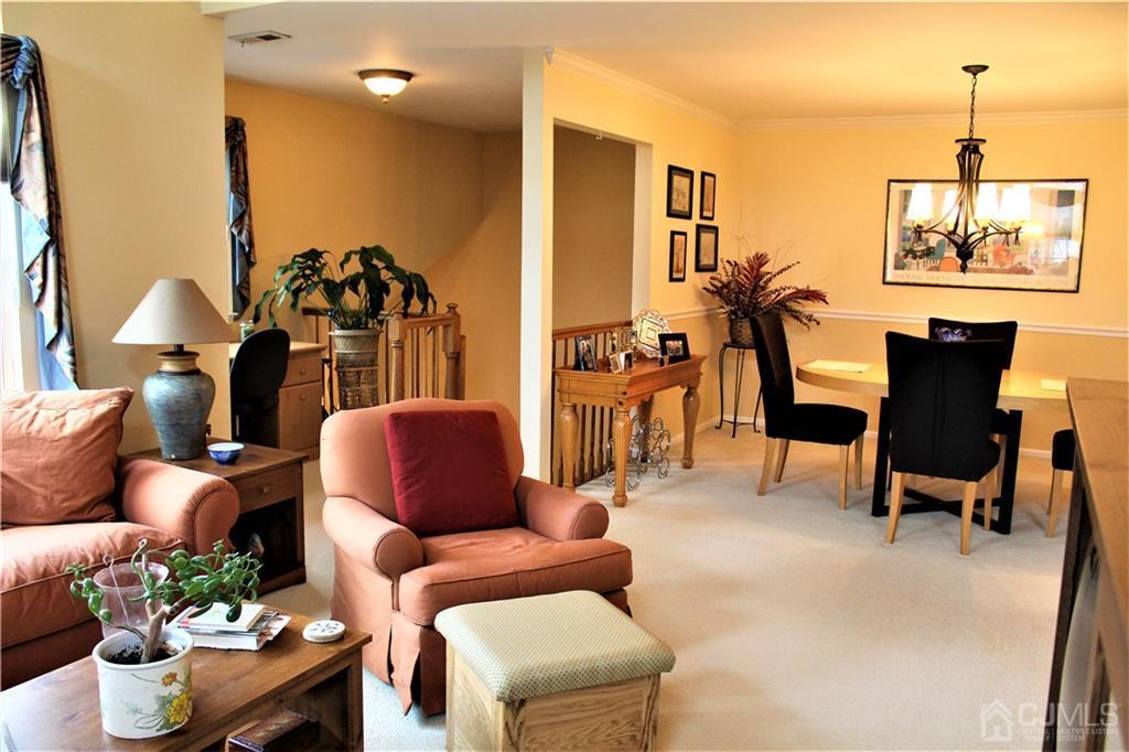 5103 Stonehedge Road, Unit 5103 Edison, NJ 08820 - Photo 3 of 25 a living room with furniture and a potted plant