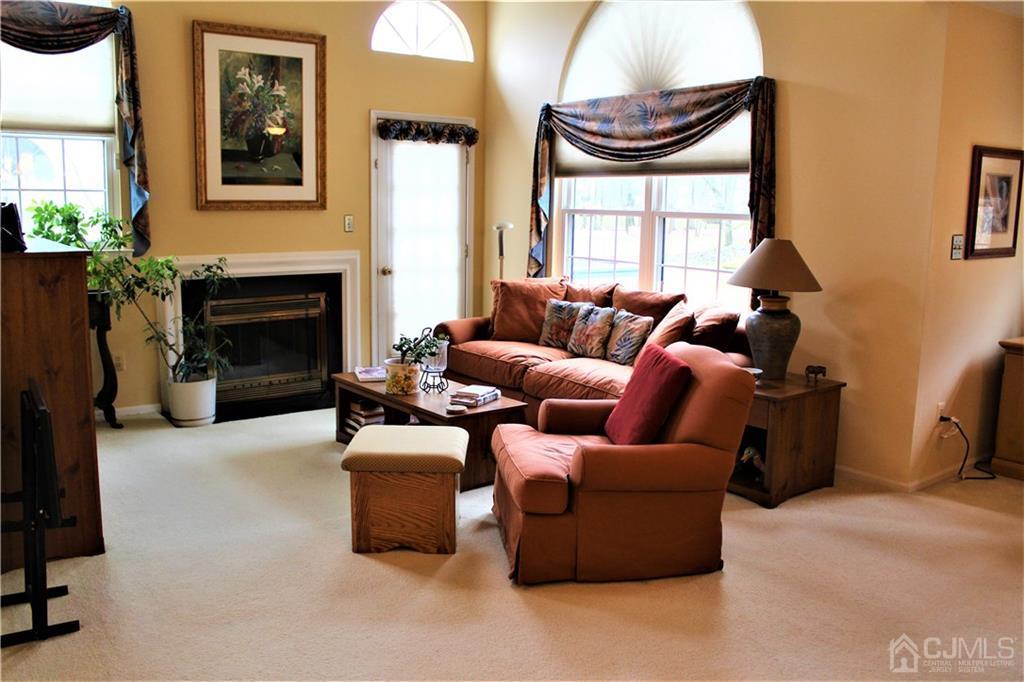 5103 Stonehedge Road, Unit 5103 Edison, NJ 08820 - Photo 5 of 25 a living room with furniture a window and a fireplace