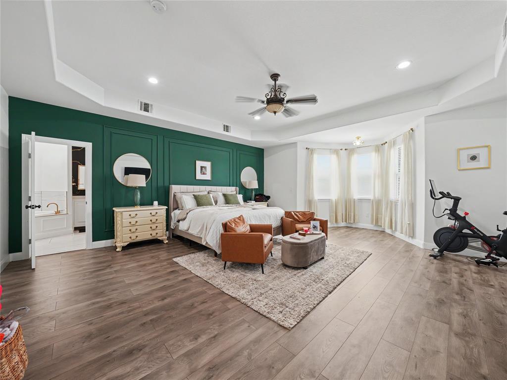 6701 Nauert Road Forest Hill, TX 76140 - Photo 18 of 40 Spacious bedroom with wood-finish flooring, a tray ceiling, and a large bay window