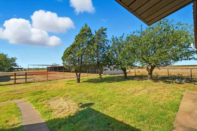 a swimming pool with an outdoor seating and a yard