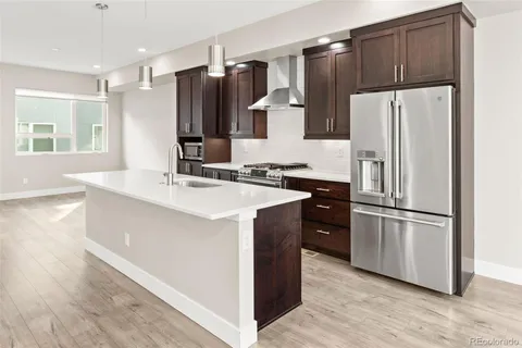 a kitchen with stainless steel appliances a refrigerator and a sink