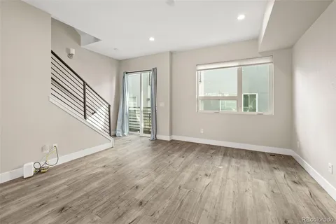 an empty room with windows and closet