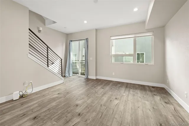 an empty room with windows and closet