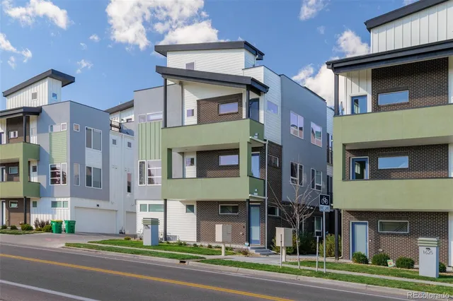 a view of a brick building next to a yard