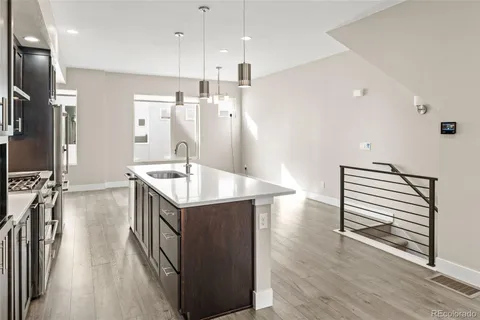 a kitchen with sink cabinets and wooden floor