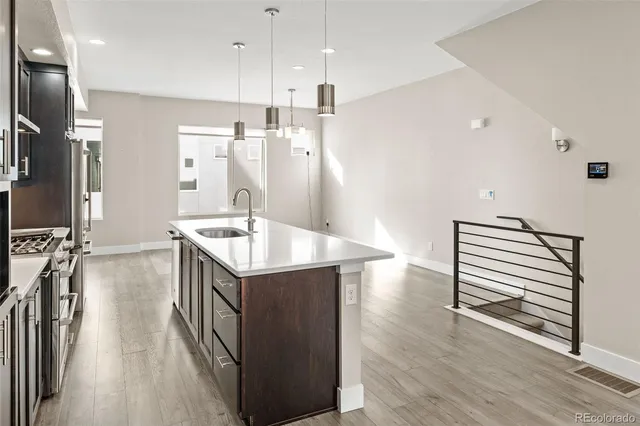 a kitchen with sink cabinets and wooden floor