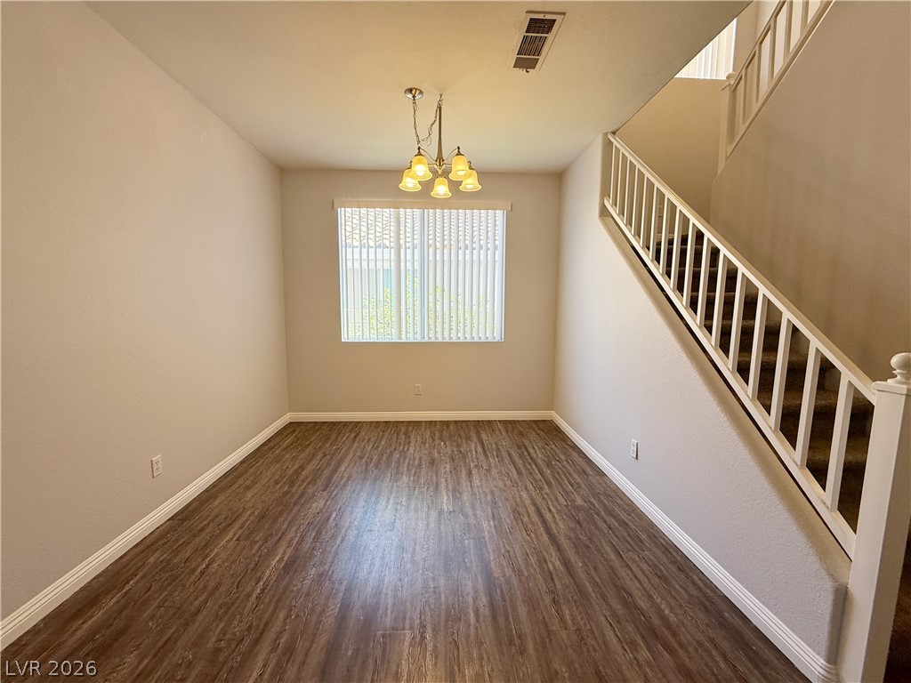 2185 Polynesia Circle Henderson, NV 89074 - Photo 5 of 37 A well-lit area featuring durable laminate flooring and a functional stairway to the upper level.