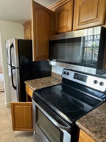 a stove top oven sitting inside of a kitchen