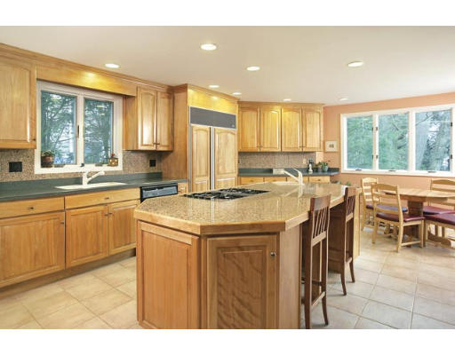 166 Ridge Avenue Newton, MA 02459 - Photo 2 of 9 a open kitchen with kitchen island a large window cabinets and stainless steel appliances