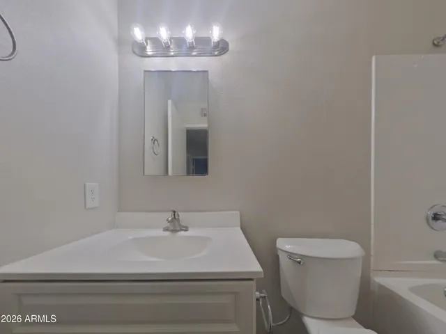 a bathroom with a toilet and a bath tub