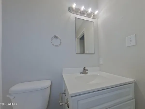 a bathroom with a sink mirror vanity and toilet
