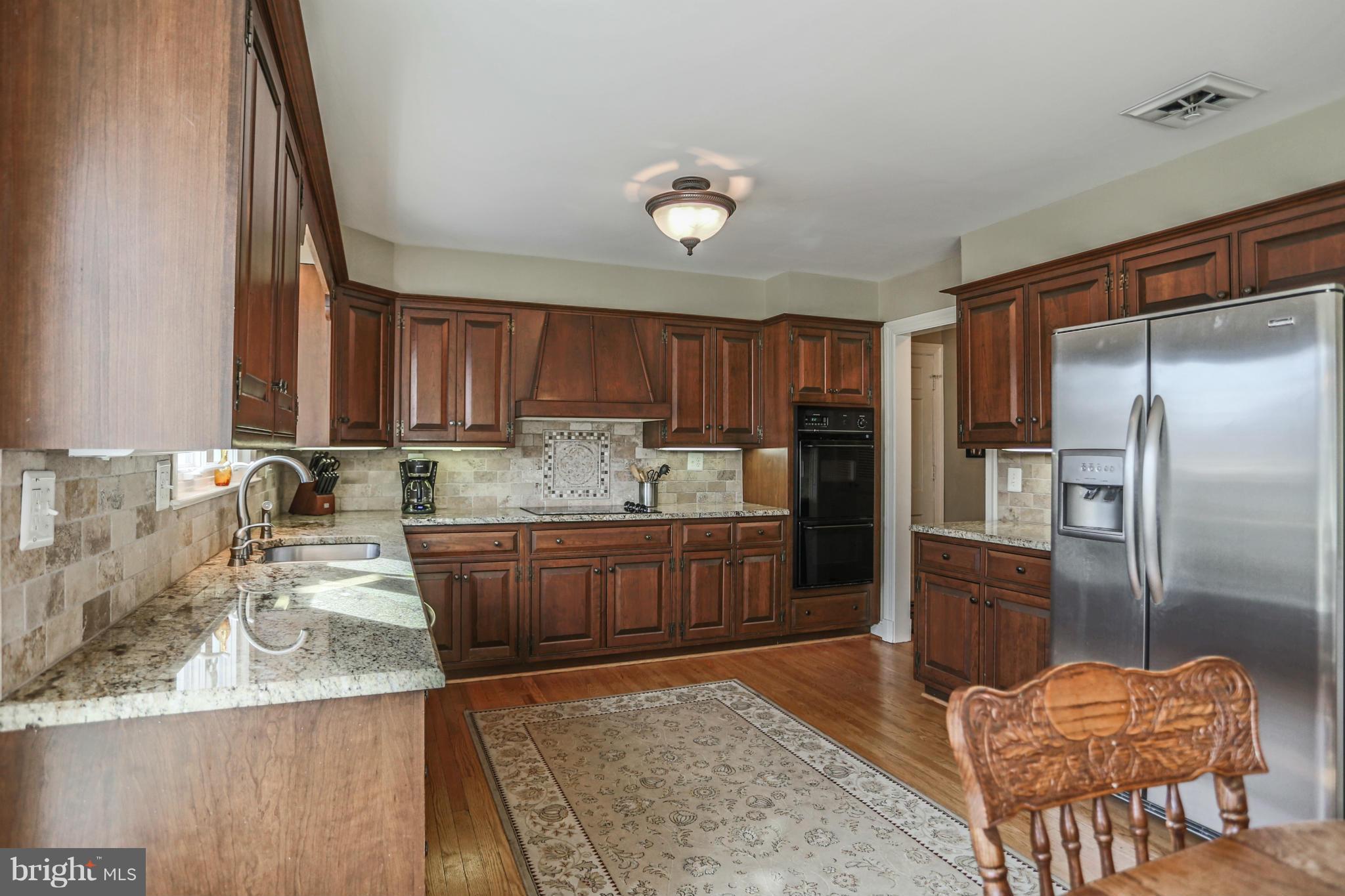 15312 Merrifields Court Silver Spring, MD 20906 - Photo 7 of 30 Kitchen with granite counters and tile backsplash