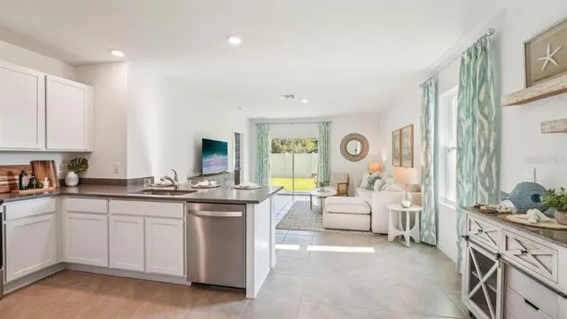 a large room with kitchen island a large white cabinets
