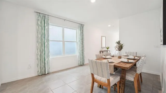 a dining room with furniture and window